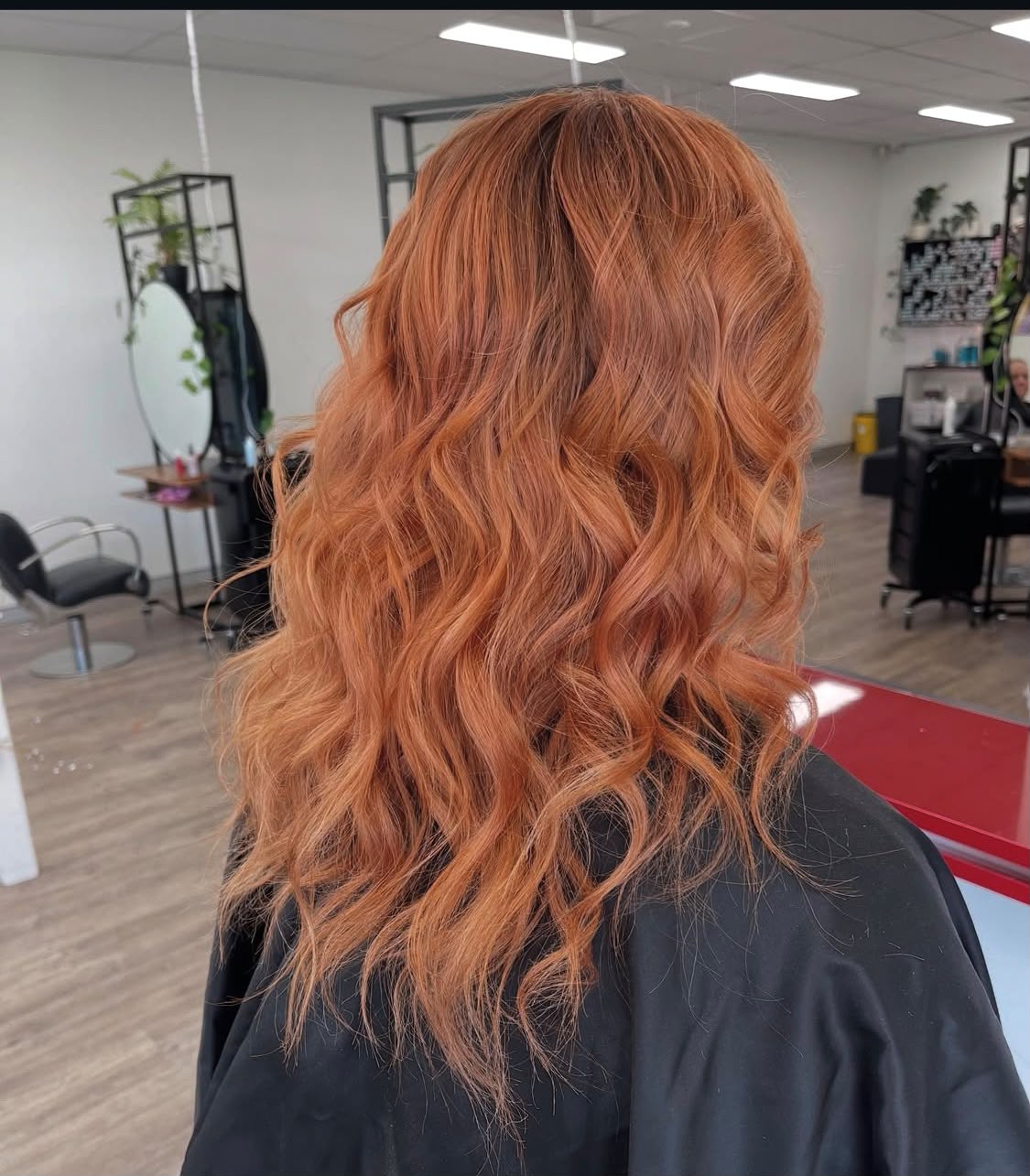 Long copper waves coloured and styled at Chisholm Hair Works