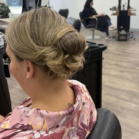An elegant styled updo created at Chisholm Hair Works